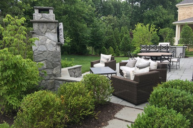 Patio - large traditional backyard concrete paver patio idea in DC Metro with a fire pit