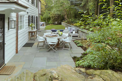 Patio - mid-sized transitional backyard stone patio idea in New York with no cover