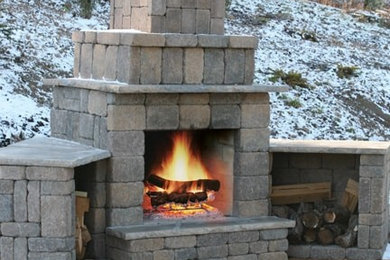 This is an example of a medium sized back patio in Other with a fire feature, concrete paving and no cover.