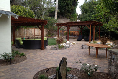 Large transitional backyard patio kitchen photo in San Diego with a pergola