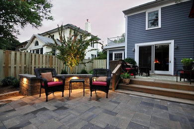 Example of a classic backyard stone patio design in DC Metro with no cover