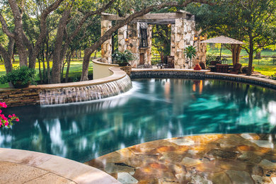 Inspiration for a mid-sized timeless backyard pool fountain remodel in Austin