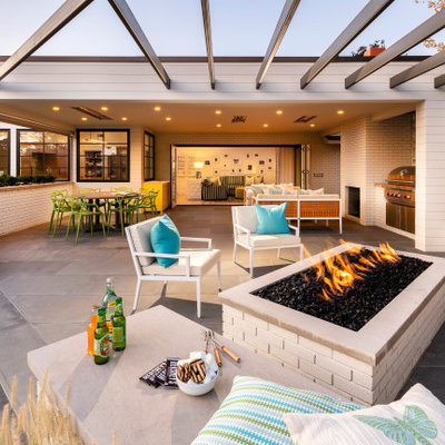 Inspiration for a huge transitional backyard tile patio remodel in Salt Lake City with a roof extension