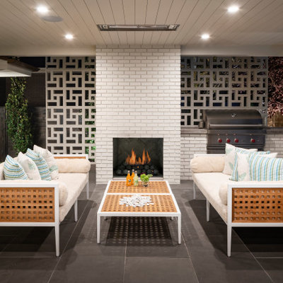 Inspiration for a mid-sized contemporary backyard tile patio remodel in Salt Lake City with a roof extension