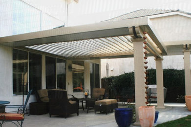 Example of a classic backyard patio design in Sacramento with an awning