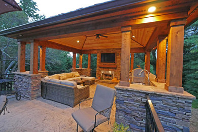 Patio kitchen - large traditional backyard stamped concrete patio kitchen idea in Other with a gazebo