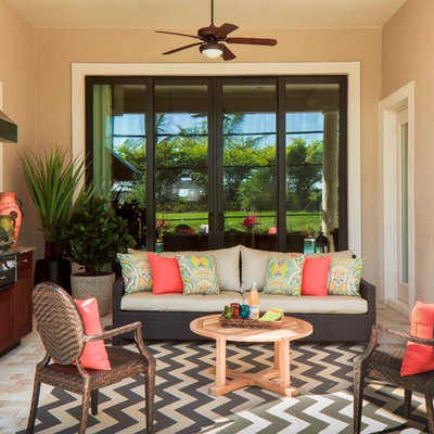 Elegant stone patio kitchen photo in Miami with a roof extension