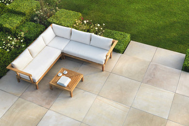Design ideas for a traditional back patio in Orange County with natural stone paving.