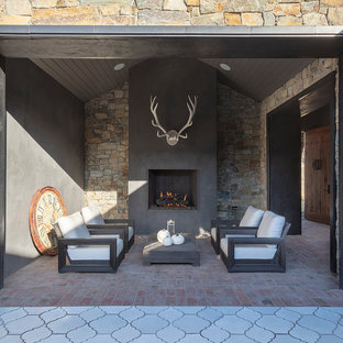 Inspiration for a rustic brick patio remodel in San Francisco with a fireplace and a roof extension