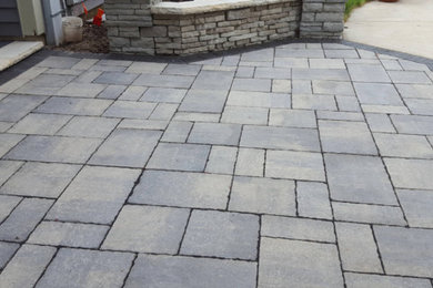 Medium sized traditional back patio with natural stone paving and no cover.
