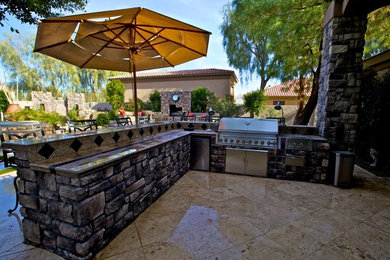 Large elegant backyard concrete paver patio kitchen photo in Phoenix with no cover