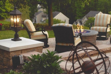 Inspiration for a large timeless backyard brick patio remodel in Richmond with a fire pit and no cover