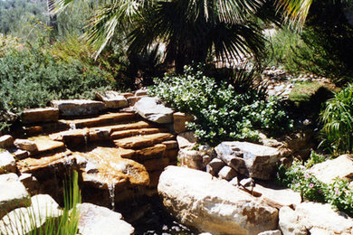Inspiration for a mid-sized rustic backyard patio fountain remodel in Phoenix with no cover