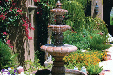 Mid-sized mountain style courtyard concrete patio fountain photo in Phoenix with no cover