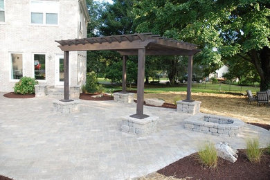 Inspiration for a large timeless backyard brick patio remodel in Other with a fire pit and a pergola