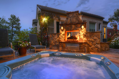 Inspiration for a large transitional backyard stone patio remodel in Denver with a fire pit and no cover
