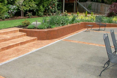 Inspiration for a mid-sized transitional backyard concrete paver patio remodel in Portland with no cover