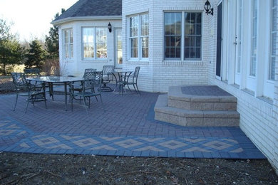 Patio - mid-sized traditional backyard brick patio idea in Chicago with no cover