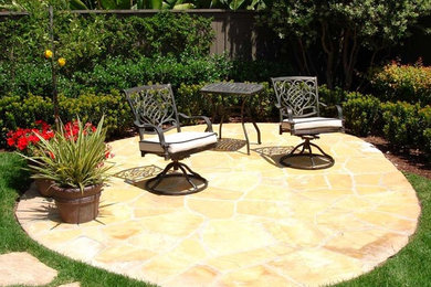 Mid-sized elegant backyard stone patio photo in San Diego with no cover