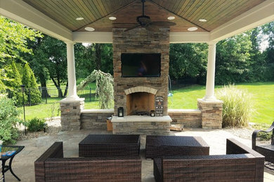Inspiration for a mid-sized timeless backyard stamped concrete patio remodel in St Louis with a gazebo