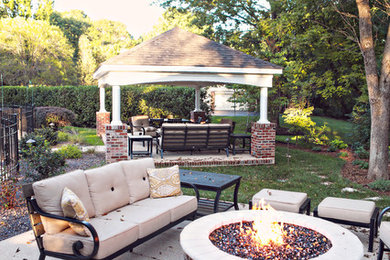 Large elegant backyard concrete paver patio photo in St Louis with a fire pit and a gazebo