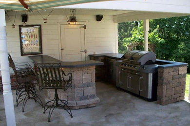 Inspiration for a large timeless backyard concrete patio kitchen remodel in Columbus with a roof extension