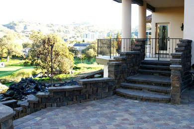 Example of a large classic backyard stone patio design in Phoenix with no cover