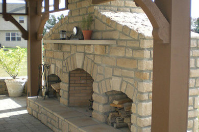 Example of a small mountain style backyard stone patio design in Columbus with a fire pit