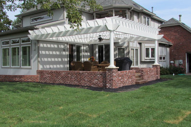 Inspiration for a large timeless backyard patio remodel in Wichita with decking and a pergola