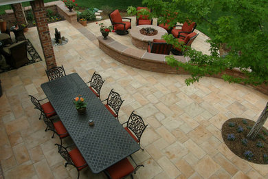 Patio - mid-sized backyard stone patio idea in Denver with a fire pit and no cover