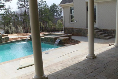 Example of a mid-sized backyard stone patio container garden design in Atlanta with no cover