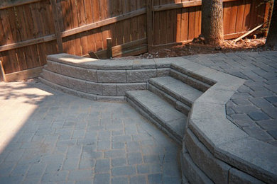 Example of a mid-sized backyard stone patio container garden design in Atlanta with no cover
