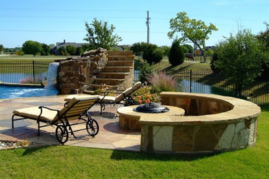 Example of a classic backyard patio design in Dallas with a fire pit