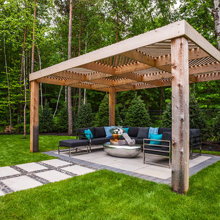 Ispirazione per un grande patio o portico classico dietro casa con un focolare, pavimentazioni in cemento e una pergola