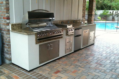 Patio kitchen - mid-sized traditional backyard brick patio kitchen idea in New Orleans with no cover