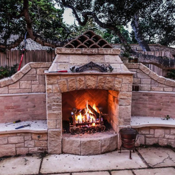 Outdoor Carmel stone fireplace with wraparound seating