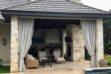 Example of a huge classic backyard patio design in Austin with a roof extension