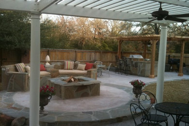 Backyard concrete patio photo in Austin with a fire pit and a pergola