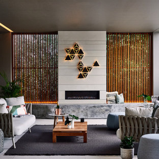 This is an example of a contemporary patio in Sydney with with fireplace and a roof extension.