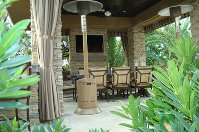 Inspiration for a tropical backyard patio remodel in Las Vegas with a gazebo