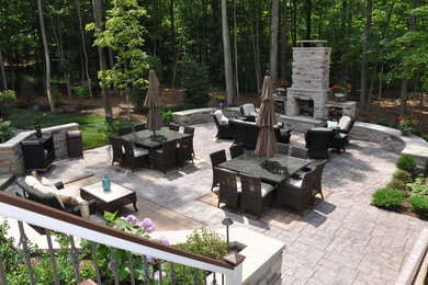 Large trendy backyard stone patio photo in Cleveland with a fire pit and no cover