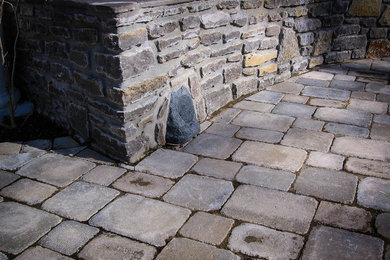 Inspiration for a mid-sized timeless backyard stone patio remodel in Nashville with no cover