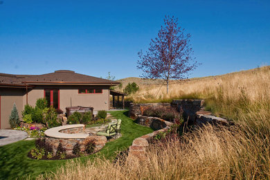 Example of a small southwest backyard stone patio design in Boise with a fire pit and no cover
