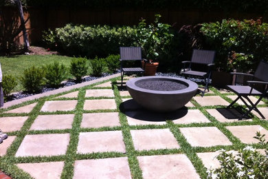 Medium sized modern back patio in Orange County with a fire feature, concrete paving and no cover.
