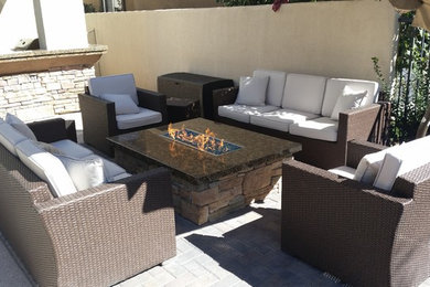 Mountain style backyard stone patio photo in Las Vegas with a fire pit