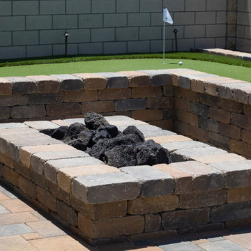 Outdoor Firepit with Stackable Seat Wall, Pavers and Artificial Grass Putting Gr