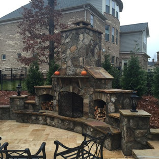 Example of a classic backyard patio kitchen design in Charlotte with no cover