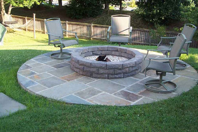 Backyard stone patio photo in Portland with a fire pit and no cover