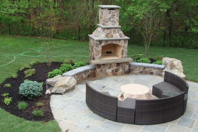 Inspiration for a large farmhouse backyard stone patio remodel in New York with a fire pit and no cover