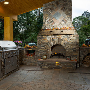 Outdoor fireplace with grill island and big green egg